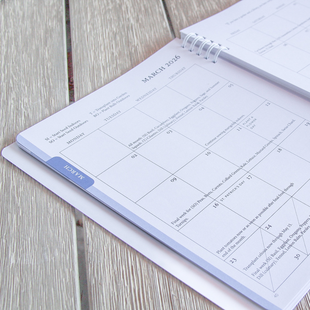 Calendar open to March 2026 inside the North Texas Garden Planner on a wooden surface