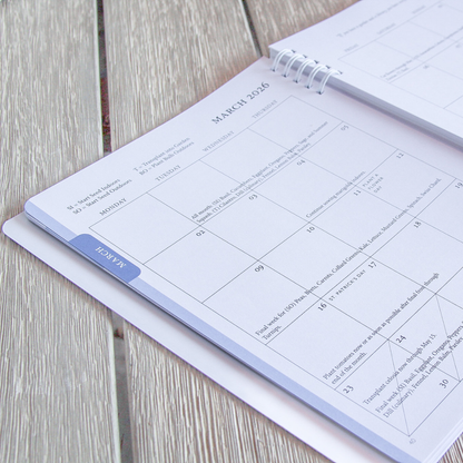 Calendar open to March 2026 inside the North Texas Garden Planner on a wooden surface